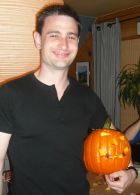 Phil poses proudly with his pumpkin he made while visiting TCT... then went back to England to carve one he could keep and roast the seeds.
