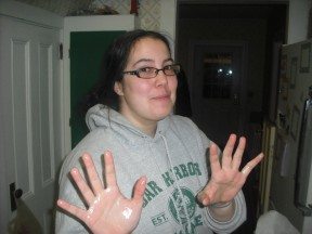 Sam got ready for the process of spreading the marshmallow mixture by oiling her hands...it didn't help a ton.